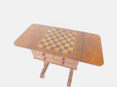 A Regency rosewood and marquetry games table by Morant, with chequerboard inlaid top having two fall leaves and two shallow drawers with boxwood outlines and knop handles, with dummy drawers to the reverse and raised upon two tapererd flat profile columns - 2