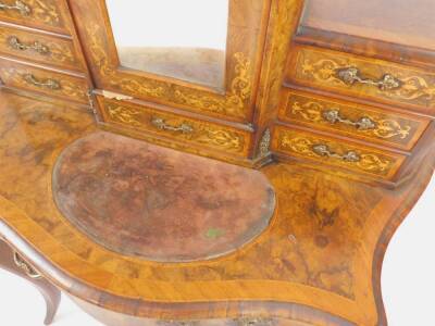 A Victorian figured walnut Bonheur du Jour, the central cupboard enclosed by a single mirrored door and with gallery top, flanked by six shallow drawers having canted corners and all with scroll marquetry inlay, the table base with serpentine front and wr - 3