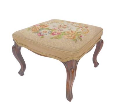 An early Victorian rosewood stool, with over upholstered floral wool needlework seat, upon French cabriole legs.