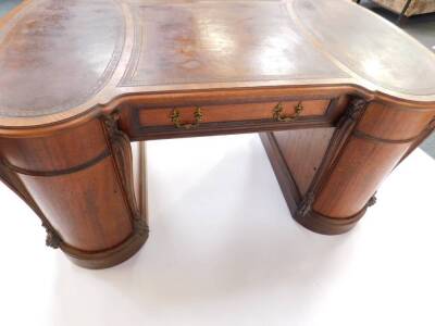 A fine late 19thC carved mahogany hour glass partner's desk in the manner of Wright & Mansfield, with three inset tooled leather skivers, with a frieze drawer and four graduated drawers to the oval section pedestals, with cupboards to the reverse and with - 3