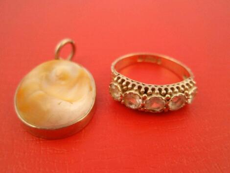 A mounted cut shell pendant and a paste set 9ct gold ring