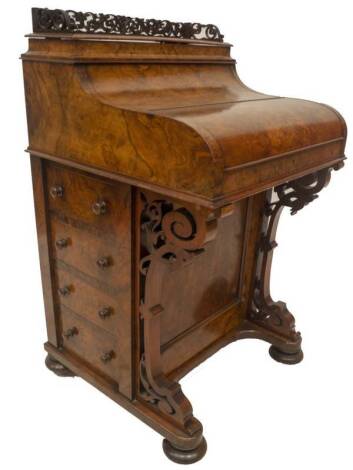 A Victorian figured walnut piano top Davenport, with fretwork gallery over a piano action release to reveal an arrangement of drawers and writing slope, pen tray and inkwell, the base having a double Wellington action for the four graduated drawers with k