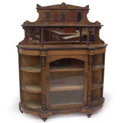 A Victorian figured walnut side cabinet, with gilt scratch carved and boxwood strung decoration to the upper part, with shelf, mirror and gilt metal mounts, the shaped base having open shelved D ends, below an ebonised moulding and enclosing a single arch