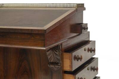 A William IV rosewood Davenport, with baluster gilt metal gallery, the slope revealing drawers and return pen slide compartment over acanthus scroll carving to the panelled fronts, and side having have solid and faux drawers to the left, and a bank of fou - 3