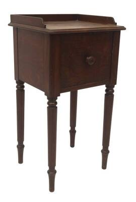 A George IV mahogany night table in the manner of Holland & Sons, with moulded tray top, single door, with button mushroom handle, taper turned legs, 80cm H, 44cm W, 39cm D.