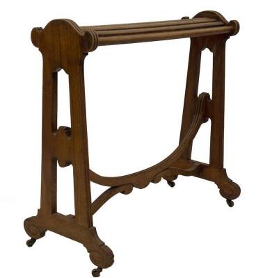 A Victorian walnut saddle stand, with slatted rail top, open slab sides, with reeded detail and scroll feet, on brass castors, and supported by a loop and scroll fluted stretcher, 90cm H, 92cm W, 47cm D. - 2