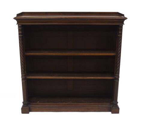 A Victorian rosewood open bookcase, with gallery moulded top, twist columns enclosing two adjustable shelves, on plinth.