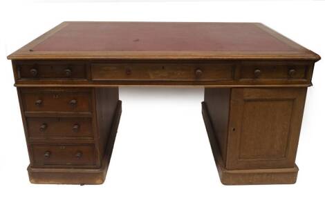 A Victorian mahogany partner's desk, with three frieze drawers and combinations of three drawers and single cupboard to each pedestal, moulded top with red leather top, 75cm H, 154cm W, 106cm D.