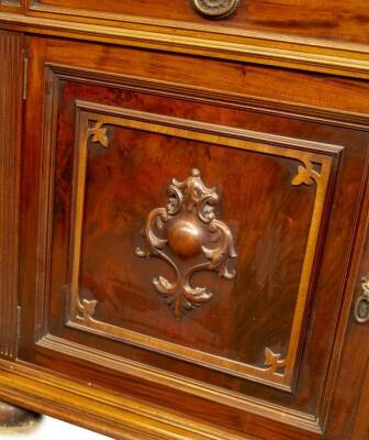 A late Victorian walnut cabinet bookcase, with egg and dart moulded cornice over two moulded and glazed doors revealing adjustable shelves, over two frieze drawers with oval pressed brass ring handles, and two panelled doors with applied and carved cartou - 2