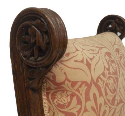 An early Victorian gothic revival oak library armchair in the manner of Augustus Welby Northmore Pugin, with William Morris style damask upholstery, stylised and carved supports, moulded base with carved and channelled legs with turned and carved stretche - 3
