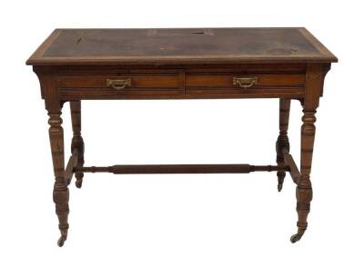 A late 19thC American walnut chamber or writing table by Gillows of Lancaster, having leatherette moulded top with lift compatment for pen tray and ink wells, over two frieze drawers, one stamped GILLOW & CO, LANCASTER, each with aesthetic brass loop hand