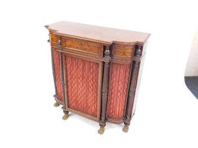 A Regency flame mahogany side cabinet in the manner of Gillows, the bowed breakfront fitted with a frieze drawer and central cupboard within tapered fluted columns and incorporating a single door with pleated curtain and wire lattice over, repeated to the - 2
