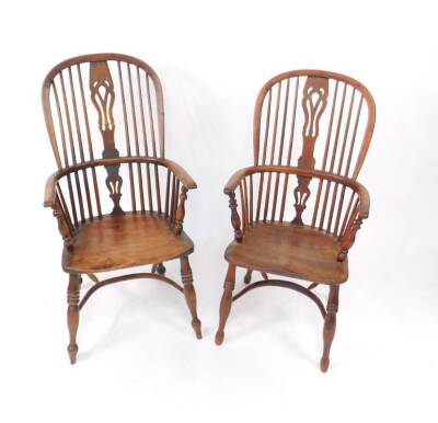 A near pair of early 19thC yew wood high back Windsor chairs, with pierced splats, turned supports, triple ring turned legs and crinoline stretcher.