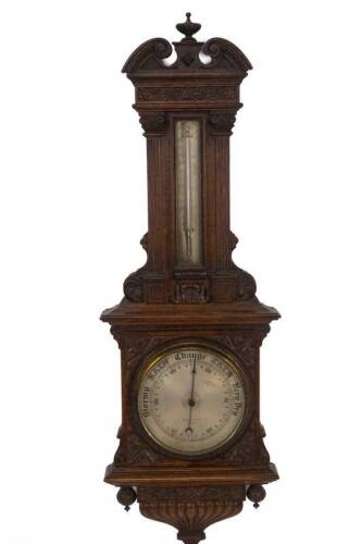 A late Victorian oak aneroid wheel barometer by Maple & Co, of architectural form, having an urn and scroll pediment, carved frieze, corinthian column enclosures to the silvered thermometer, over a 19cm Dia. dial marked MAPLE & Co Ltd, LONDON, 108cm H.