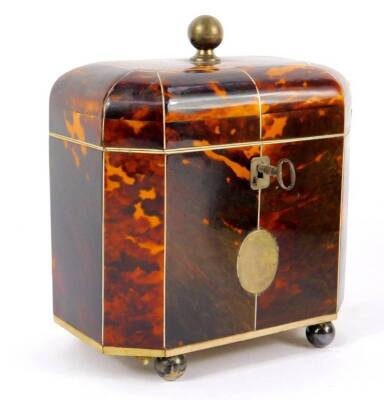 A George III octagonal tortoiseshell tea caddy, with ivory line inlay, the domed lid with silver ball knop opening to reveal twin lidded compartments, the front with silver and reserve, raised on silver ball feet, with key, 15cm H, 13cm W, 8.5cm D.