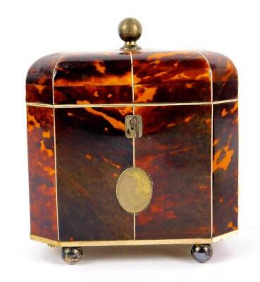 A George III octagonal tortoiseshell tea caddy, with ivory line inlay, the domed lid with silver ball knop opening to reveal twin lidded compartments, the front with silver and reserve, raised on silver ball feet, with key, 15cm H, 13cm W, 8.5cm D. - 2