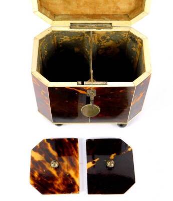 A George III octagonal tortoiseshell tea caddy, with ivory line inlay, the domed lid with silver ball knop opening to reveal twin lidded compartments, the front with silver and reserve, raised on silver ball feet, with key, 15cm H, 13cm W, 8.5cm D. - 5