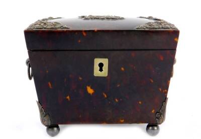 A Victorian tortoiseshell sarcophagus tea caddy, with embossed silver mounts and pair of ring and ball handles, the hinged lid opening to reveal a single lidded compartment, raised on four silver ball feet, Birmingham 1886, 10.5cm H, 14cm W, 8.5cm D. - 2