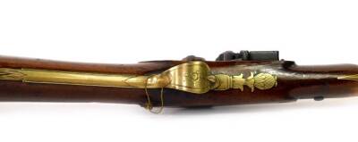 A 19thC brass blunderbuss by Hutchinson, the barrel stamped Dublin MF 1461 and with two proof marks, the lock plate with makers mark, with engraved brass trigger guard and furnishishings, the butt plate numbered to match the barrel, the walnut stock stamp - 2