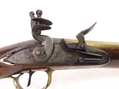 A 19thC brass blunderbuss by Hutchinson, the barrel stamped Dublin MF 1461 and with two proof marks, the lock plate with makers mark, with engraved brass trigger guard and furnishishings, the butt plate numbered to match the barrel, the walnut stock stamp - 4