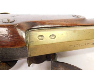 A 19thC brass blunderbuss by Hutchinson, the barrel stamped Dublin MF 1461 and with two proof marks, the lock plate with makers mark, with engraved brass trigger guard and furnishishings, the butt plate numbered to match the barrel, the walnut stock stamp - 7
