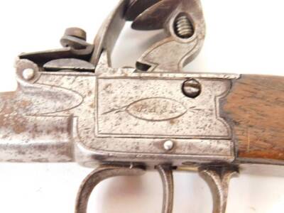 An early 19thC flintlock pistol by Bass of London, with plain walnut handle, 17cm.. - 2