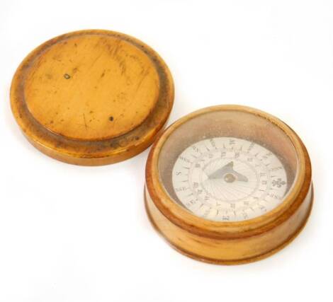 A 19thC pocket compass, in a turned boxwood case with push on lid, 6cm Dia.