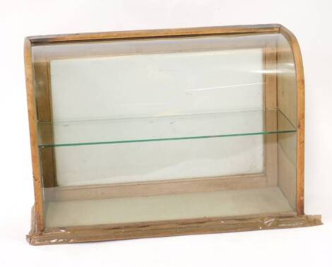 A Victorian shop counter display case, with bowed glass front, fitted a glass shelf and with hinged fall back, 49cm H, 34cm W, 19cm D.