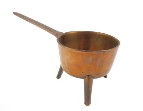 An 18thC bronze skillet or posnet, of long handled form, raised on tripod feet, 34.5cm L.