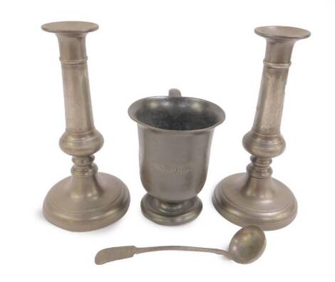 A 19thC pewter pint tankard, Victorian pewter cream ladle, and a pair of pewter candlesticks, 22.5cm H. (4)