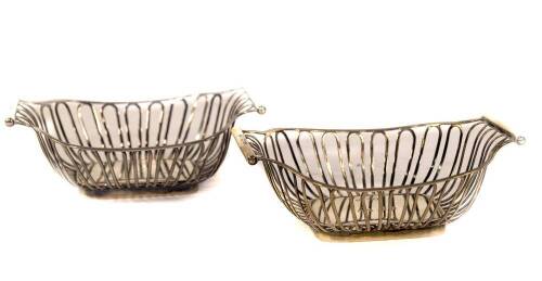 A pair of Edwardian silver oblong bonboniere baskets, with reeded frames and wire work bodies, with plain bases, one inscribed 'presented to Miss A Dixon by the Members of Rampton Choral Society, 9th June 1908', the other 'AD', London 1902, makers Harriso