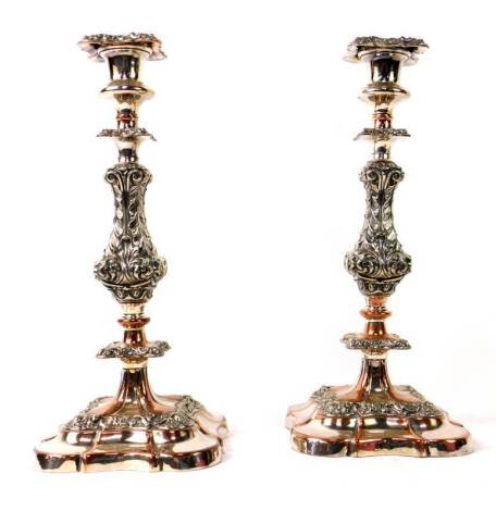 A pair of Victorian silver plated candlesticks, with detachable square sconces and ornate acanthus and scroll baluster columns having flanged collars on stepped shaped square bases, on copper, 34cm H.