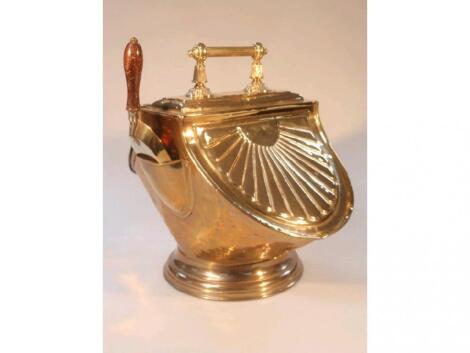 A Victorian embossed brass coal scuttle with reeded handle and shovel