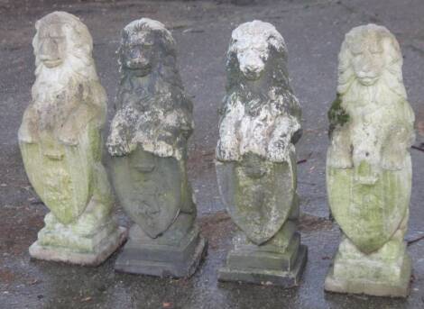 A harlequin set of four stone lion finials, on square plinth bases, 78cm H etc. (4)