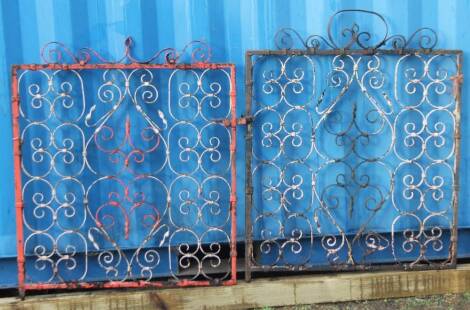 Two late Victorian cast iron garden gates, each of rectangular form intricately designed with scrolls and partially painted, 114cm H, 91cm W.