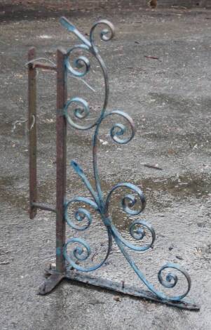 An early 20thC cast iron corner bracket, of scroll form, partially painted, 90cm W.