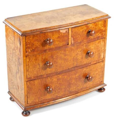 A 19thC apprentice piece bird's eye maple bowfront chest, of two short and two long drawers, on compressed orb feet, 29cm H, 32cm W, 14cm D.