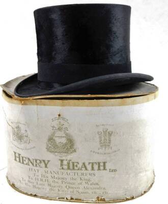 An early 20thC top hat, with black ribbon, Tress & Co Lazenby & Baxter label, 16cm H, internal measurements 19.5cm x 16cm, in part Henry Heath packaging.