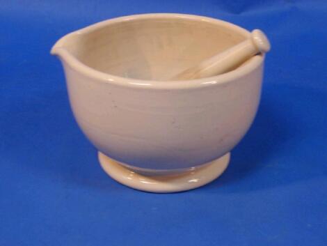 A large stoneware pestle and mortar