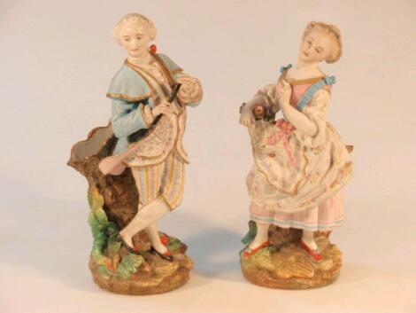 A pair of 19thC bisque porcelain spill vases modelled as figures in 18thC dress