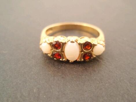 A 9ct gold dress ring set with opals and garnets