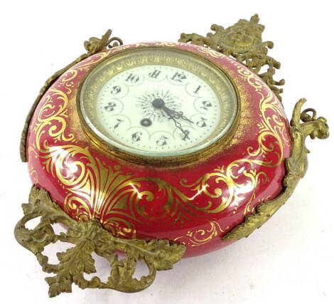 A late 19th/early 20thC French hanging Cartel type timepiece, the red ceramic case decorated in gilt and mounted with gilt metal stylised handles, scrolls, masks etc., the enamel dial with Arabic numerals, brass movement to reverse, 39cm H.