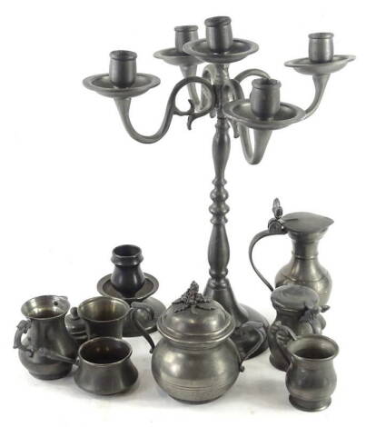 A Continental pewter four branch candelabrum, and various pewter measures etc.