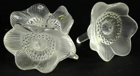 A Lalique glass candlestick, modelled in the form of three anenomies, stamped Lalique France, 12cm W and a Lalique anenome. (2)