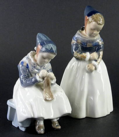 Two similar Royal Copenhagen porcelain figurines, each depicting a young girl wearing Danish national costume, printed mark in green and blue wave mark, being number 1314 & Amager Girl by Lotte Benter, 19cm, one bearing paper label for Forma.
