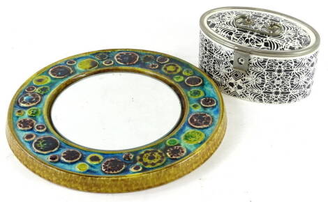 A Studio ceramic wall mirror, decorated with roundels in turquoise blue and brown, possibly Scandinavian, 34cm dia. and a Continental pottery oval box, printed in black within silver coloured metal borders (AF), 21cm W.