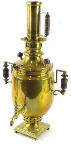 A Continental brass samovar, with turned wooden handles, on bun feet, 55cm H.