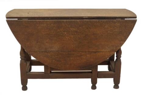 An early 18thC oak gate leg table, with oval drop leaf top, frieze drawer, baluster turned legs and feet, square framing, 75cm H, 143cm W, 124cm D.