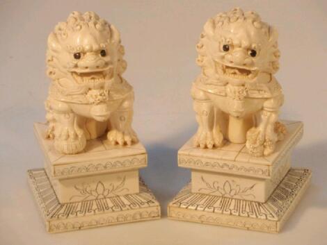 A pair of Chinese ivory carved figure of lion dogs