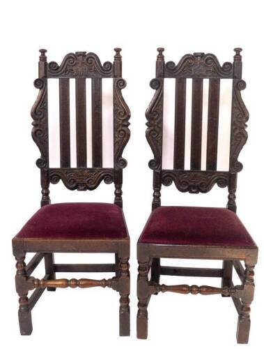 A pair of late 17thC oak high back chairs, with tulip head and scroll carved cresting rail, S scroll baroque supports, triple splat back, drop in seats, turned and square framing, 47cm W.